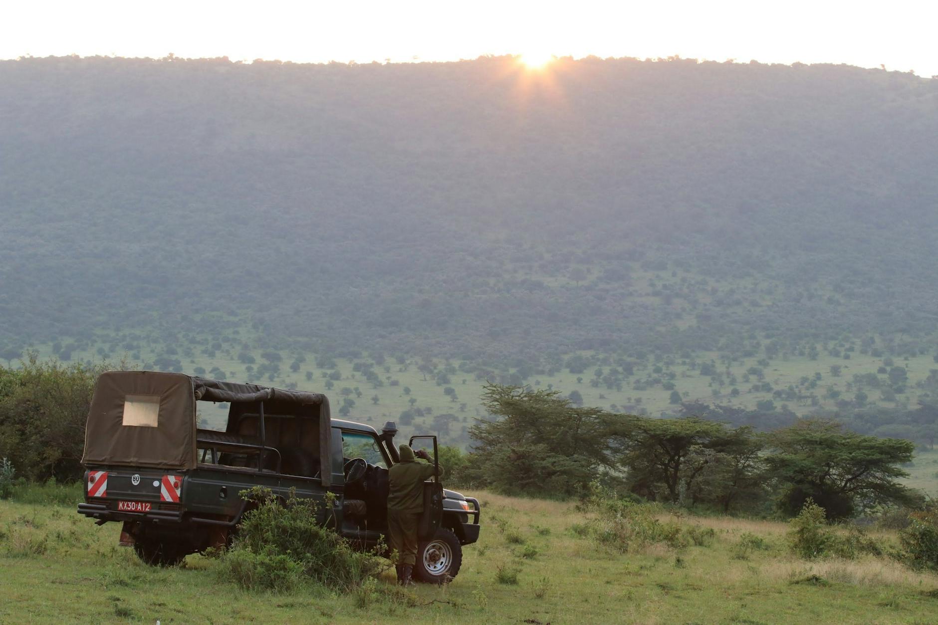 Safari game drive vehicle with tourists in Laikipia Kenya