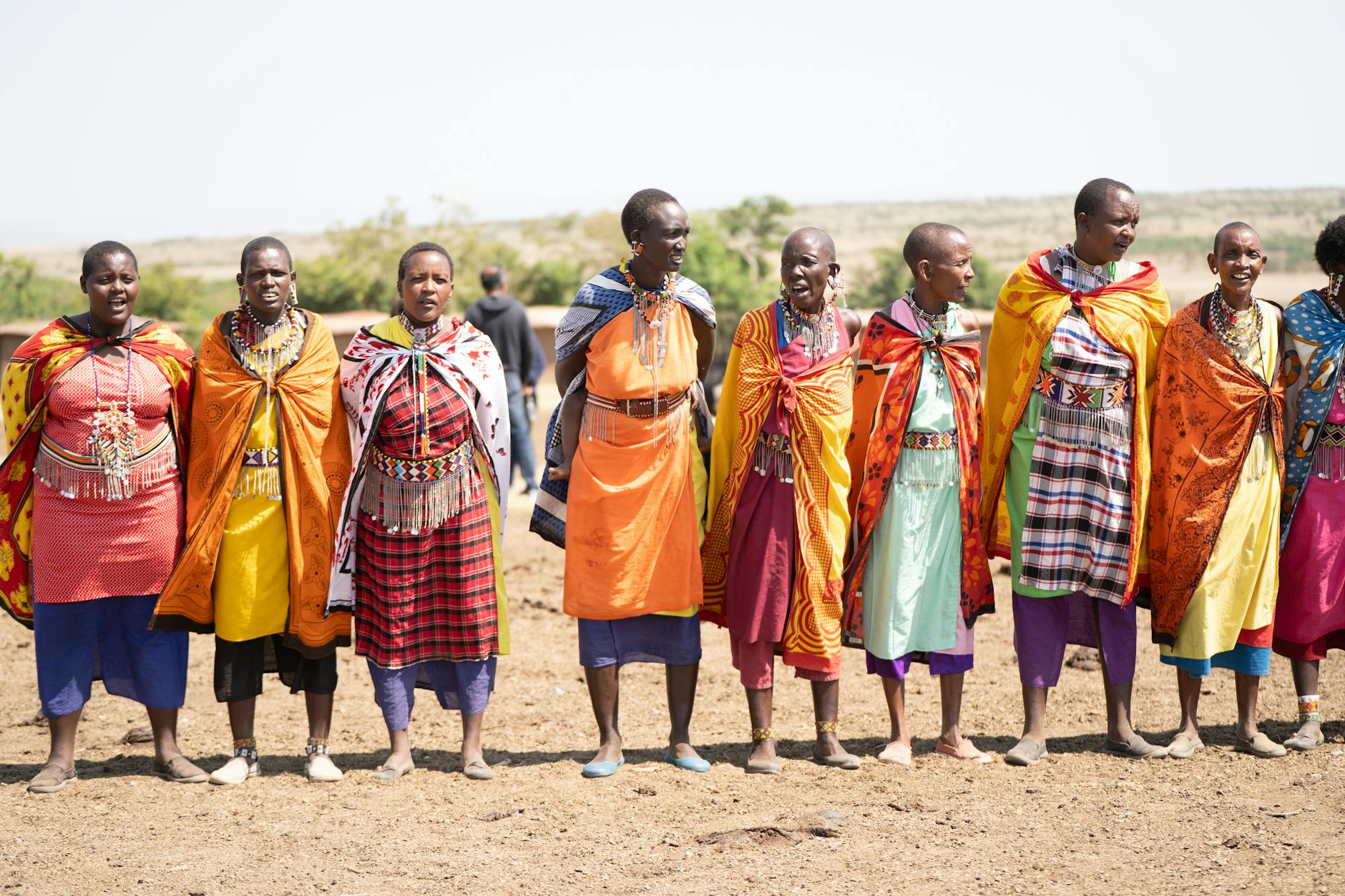A group of Maasai people in traditional attire celebrating on the Kenyan plains near Laikipia