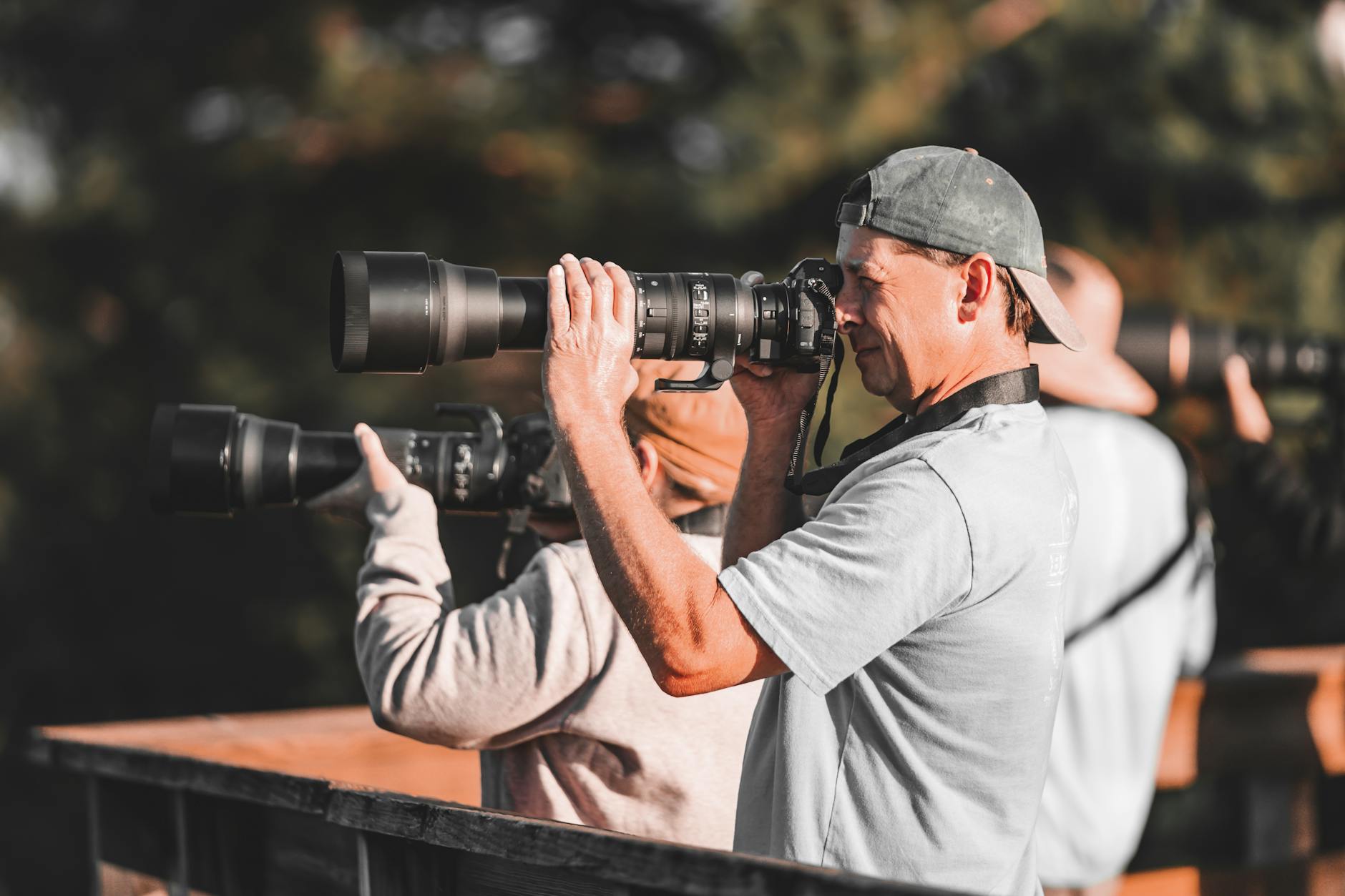 Wildlife photographer with a telephoto lens on safari